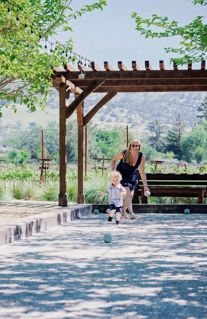 Laura playing bocce with her son.